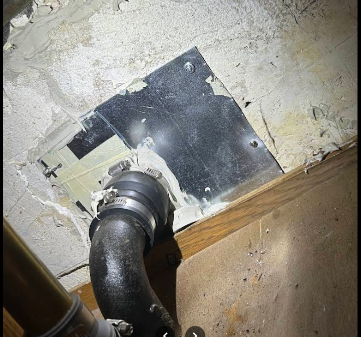 Pipe penetration sealed with a metal plate to block mice, NYC
