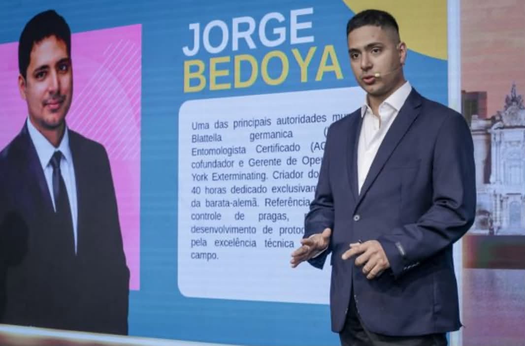 Jorge Bedoya, ACE, presenting on German cockroach control at ExpoPrag 2026 in São Paulo; the slide names him a leading Blattella germanica authority and co-founder of New York Exterminating