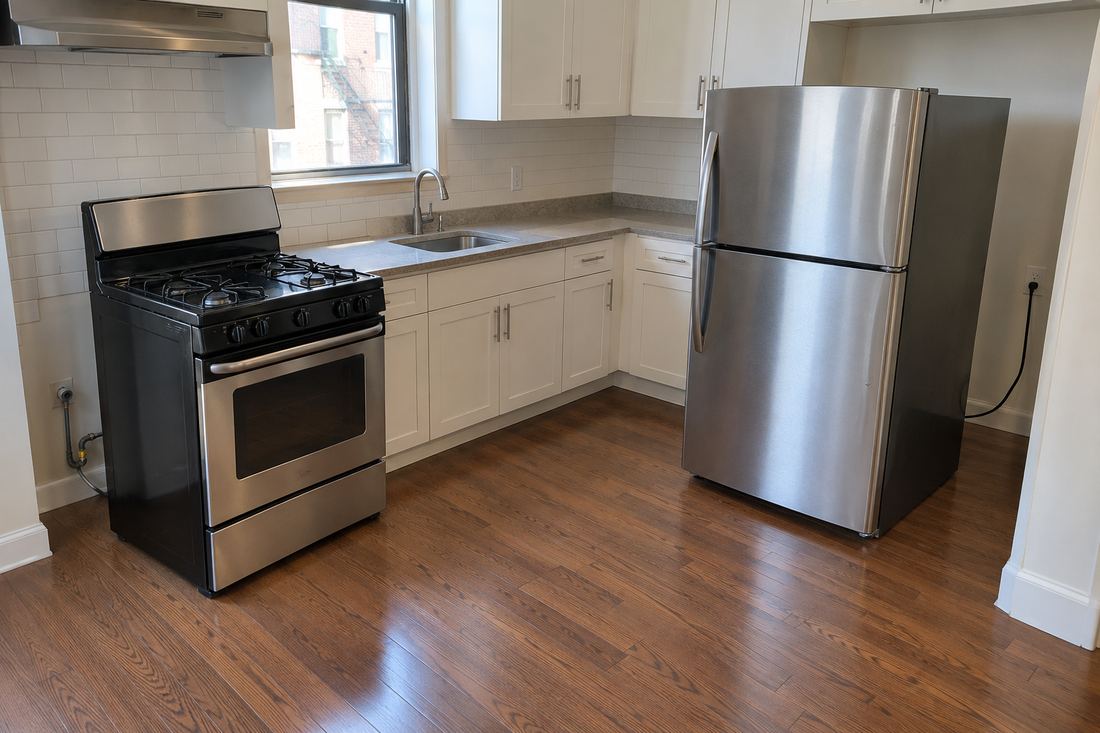 NYC rental kitchen with the stove and refrigerator pulled out for a German cockroach treatment