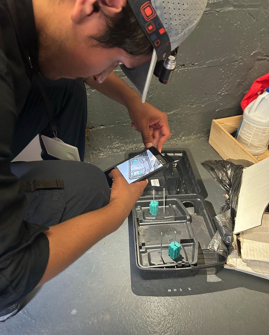NYE technician dating a glue monitor on a kitchen floor