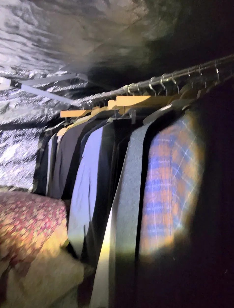 Garments hanging in spaced rows inside the NYE heat chamber