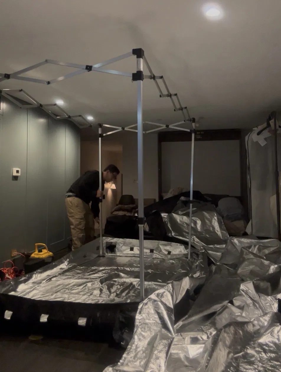 New York Exterminating technician setting up a heat chamber in a Brooklyn brownstone