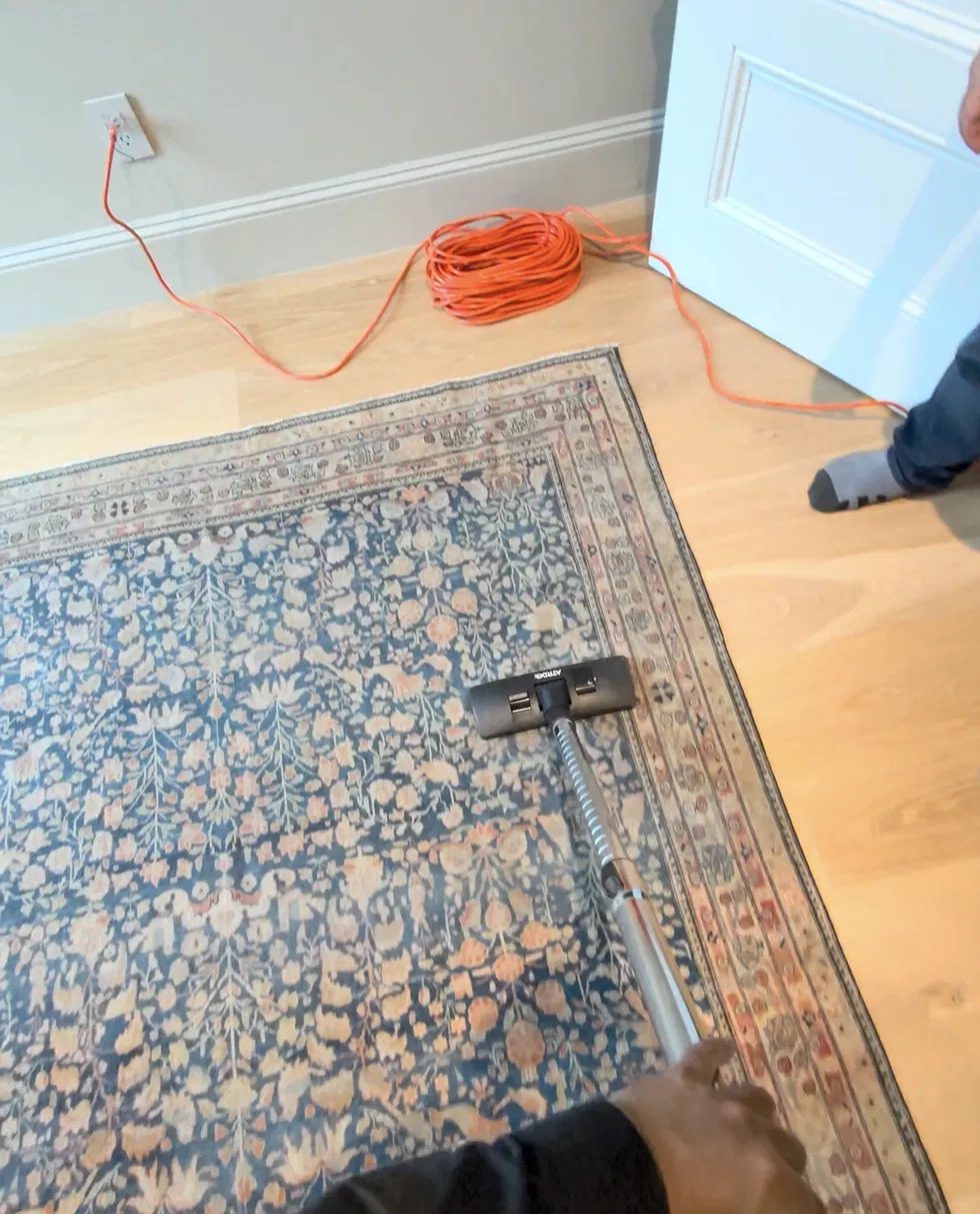 Backpack HEPA vacuum on the front of a rug