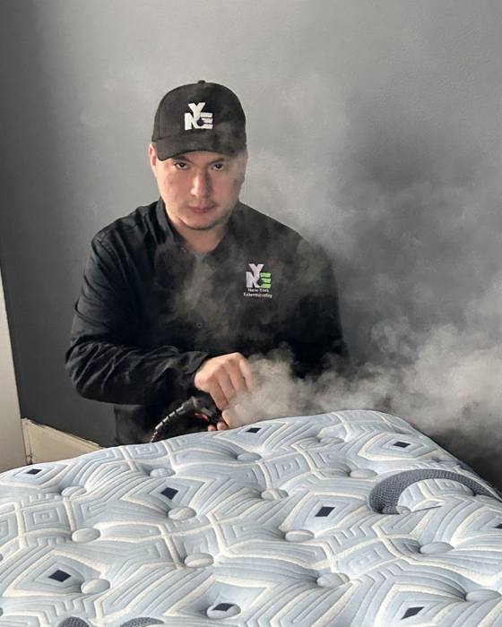 NYE technician steaming a mattress seam